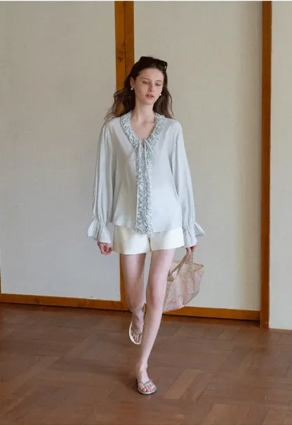 Long sleeve shirt with ruffled neckline and gathered cuffs