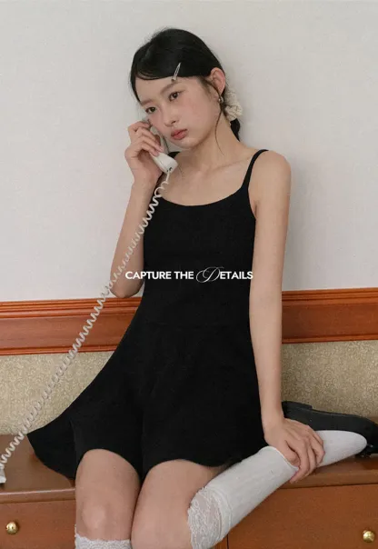 Sleeveless dress with thin straps and flared skirt