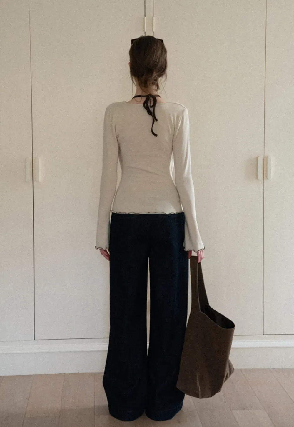 Beige Long-Sleeve Top with Ruffled Hem and Bow Tie Back