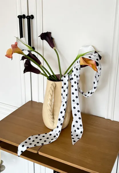 Elegant polka dot neck tie with bow design for women's fashion.