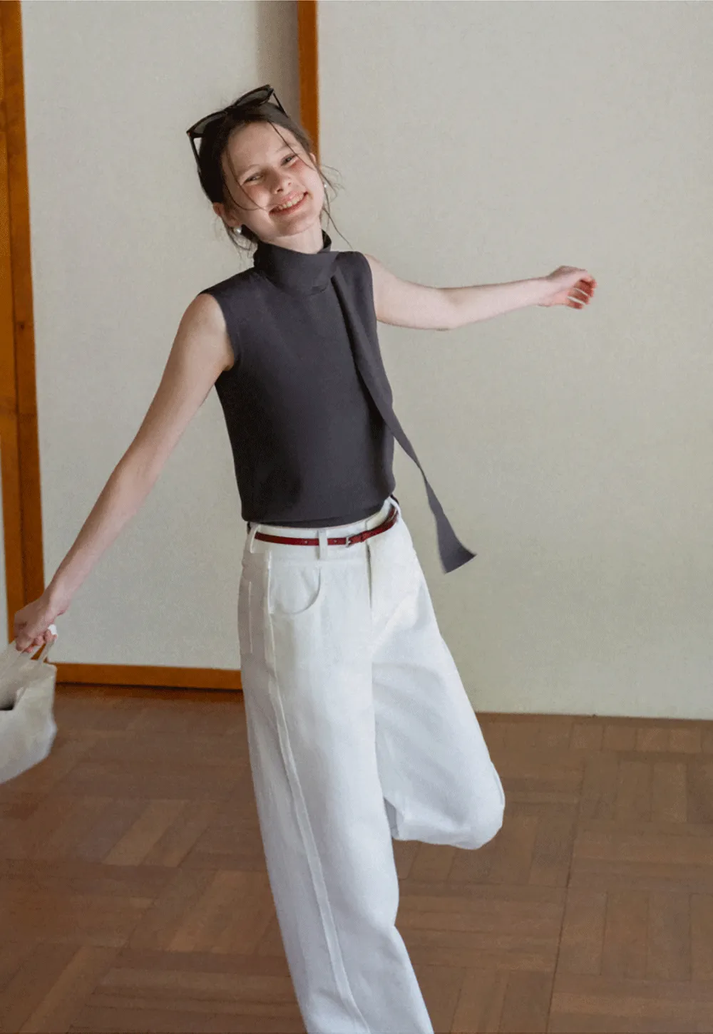 Sleeveless high neck knit top with side tie detail