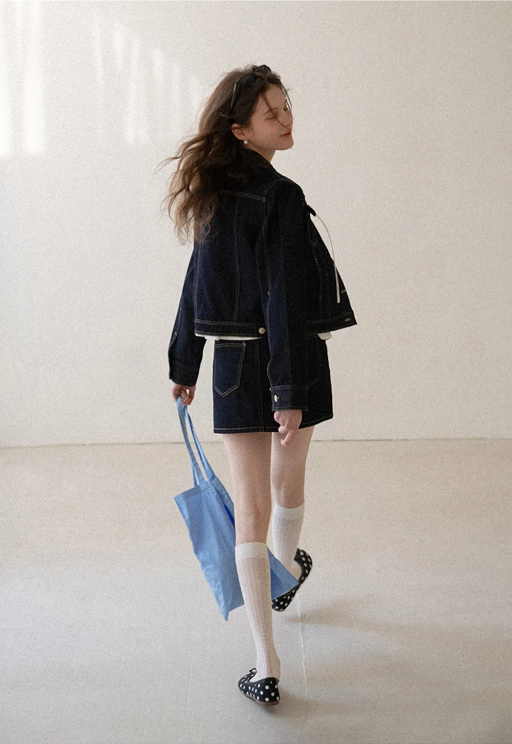 A-line denim skirt with front pocket design and adjustable waistband.