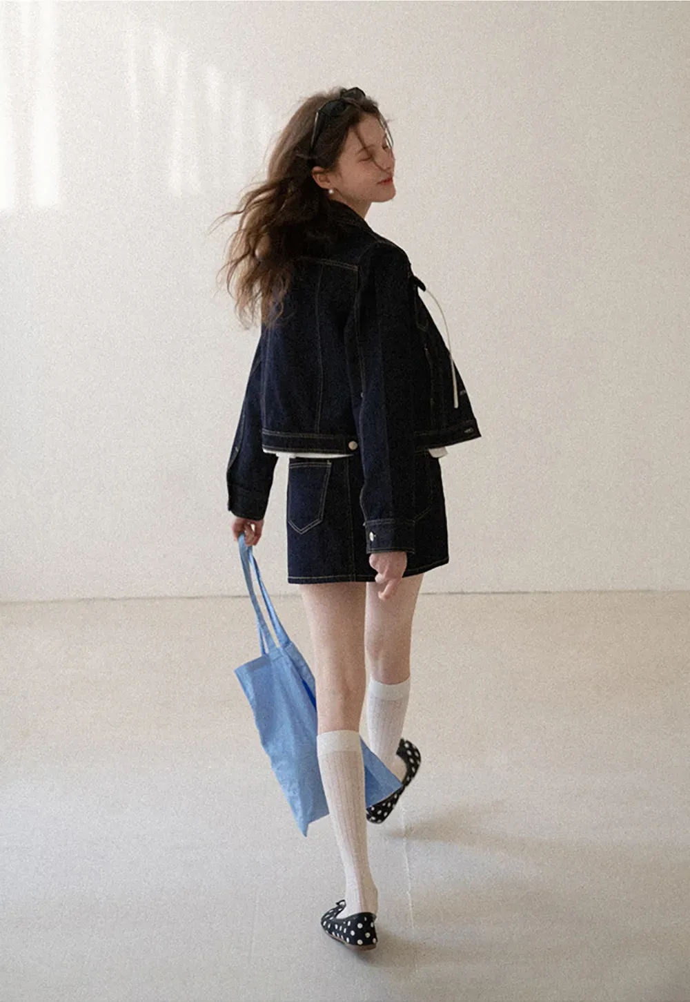 A-line denim skirt with front pocket design and adjustable waistband.