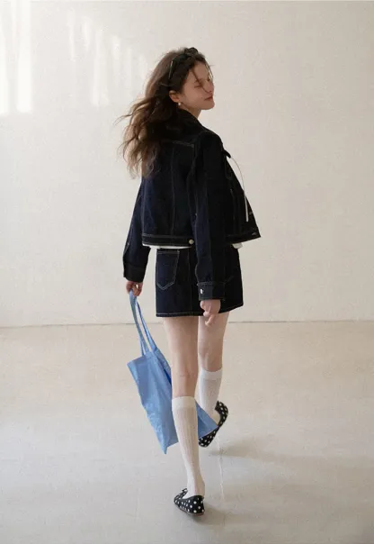 A-line denim skirt with front pocket design and adjustable waistband.