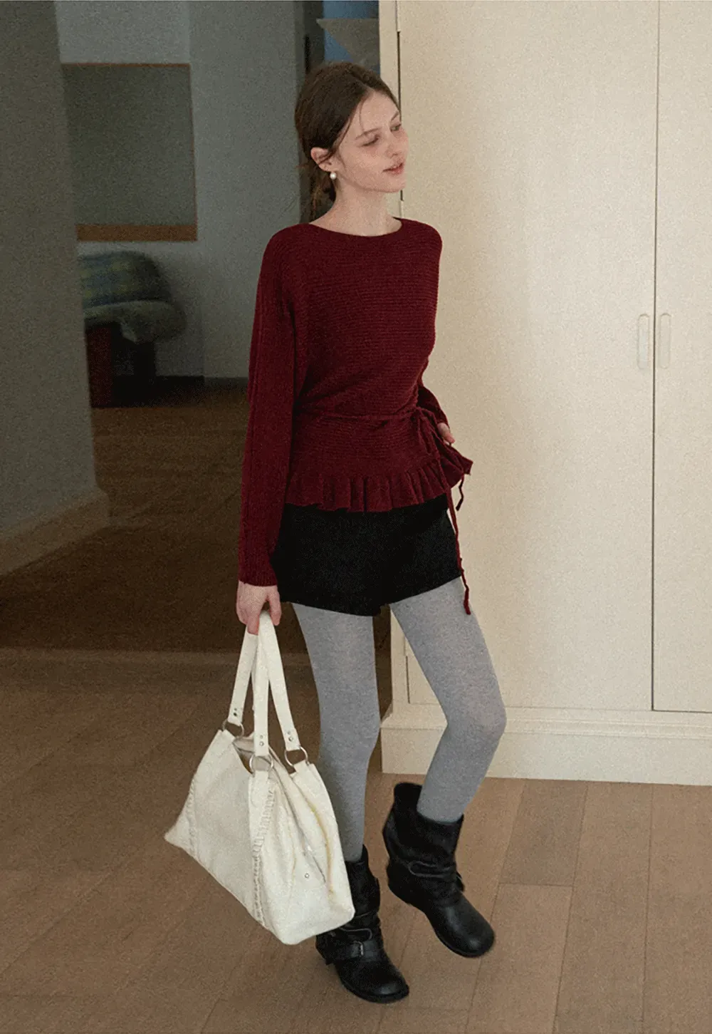 Ribbed knit sweater with tie back and flared hem design