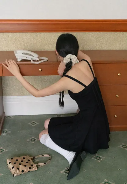 Sleeveless dress with thin straps and flared skirt