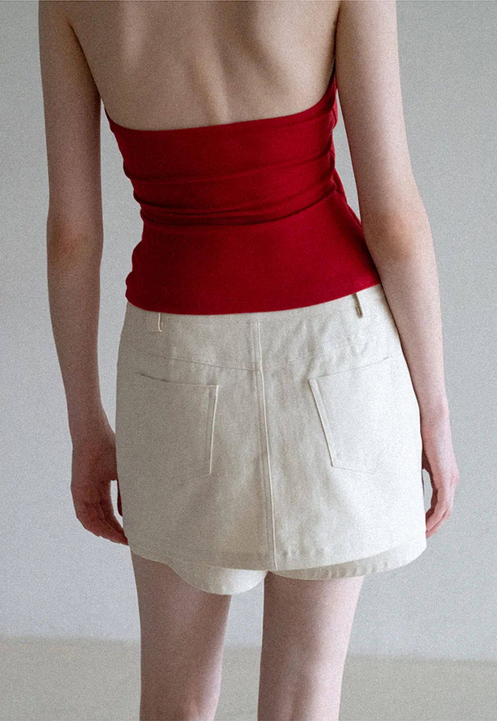 High waist pleated mini skirt with button front design