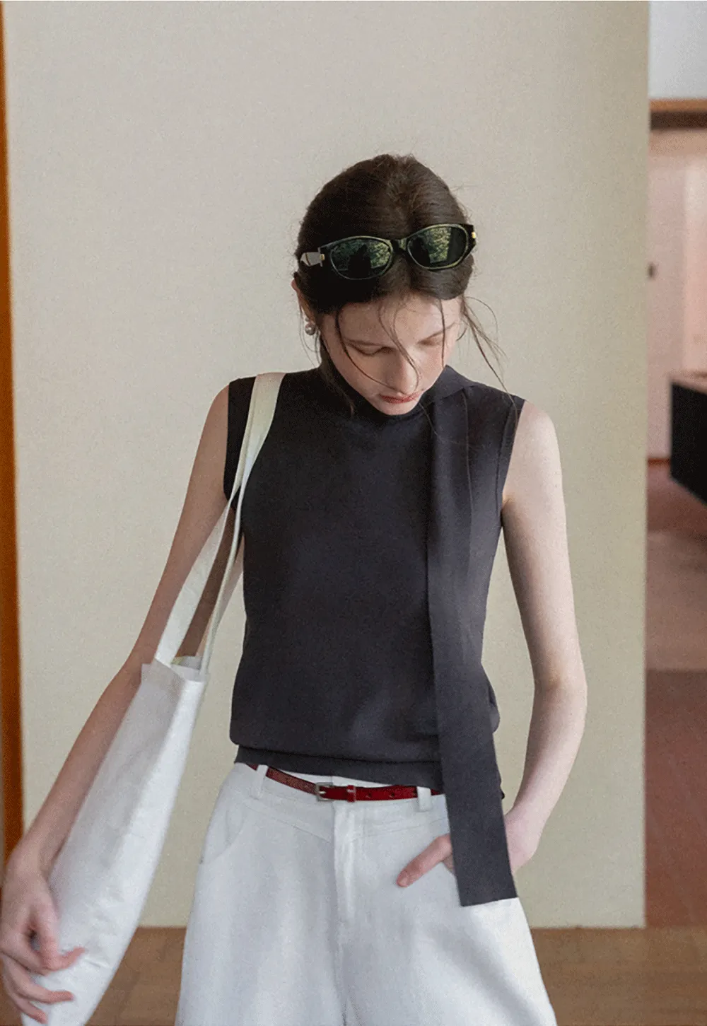 Sleeveless high neck knit top with side tie detail