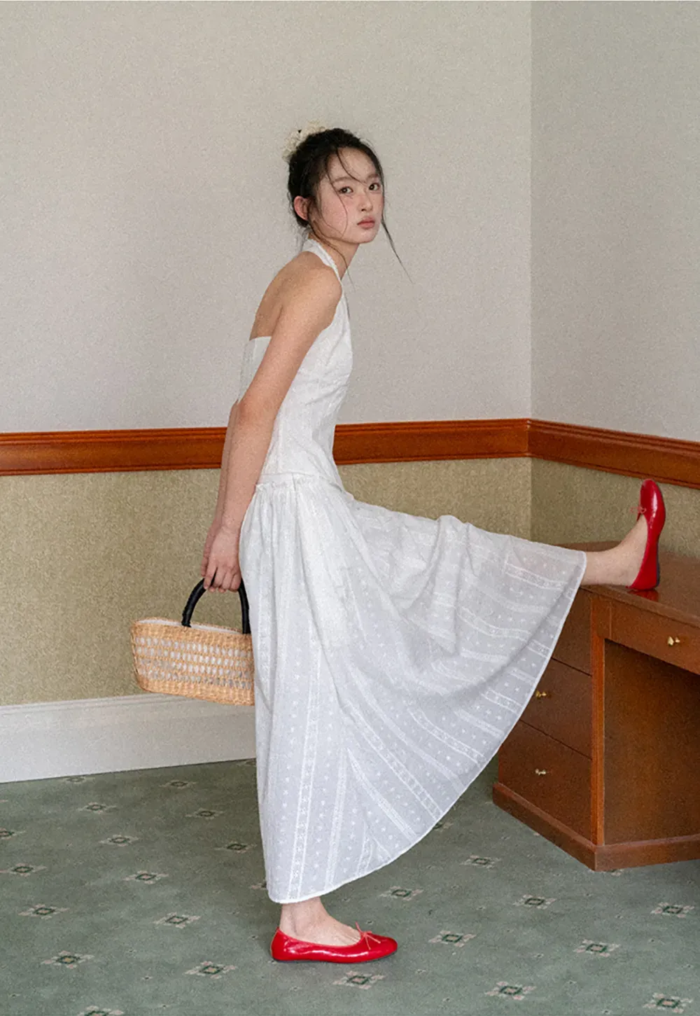 Halter neck sleeveless top with buttons and pleated skirt