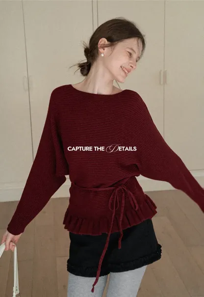 Ribbed knit sweater with tie back and flared hem design