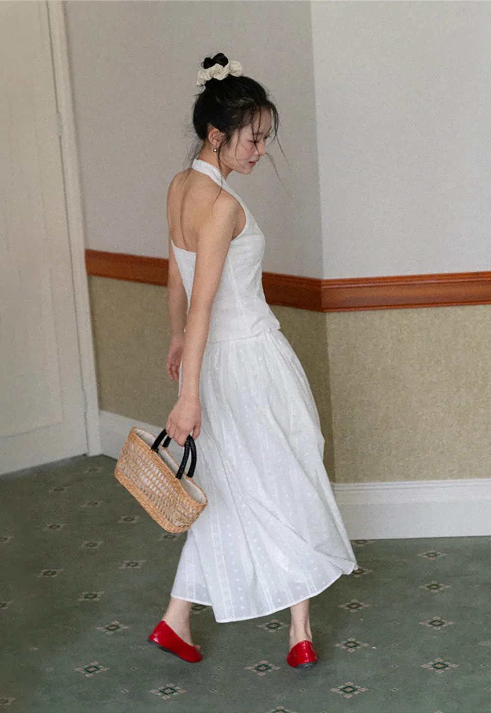 Halter neck sleeveless top with buttons and pleated skirt