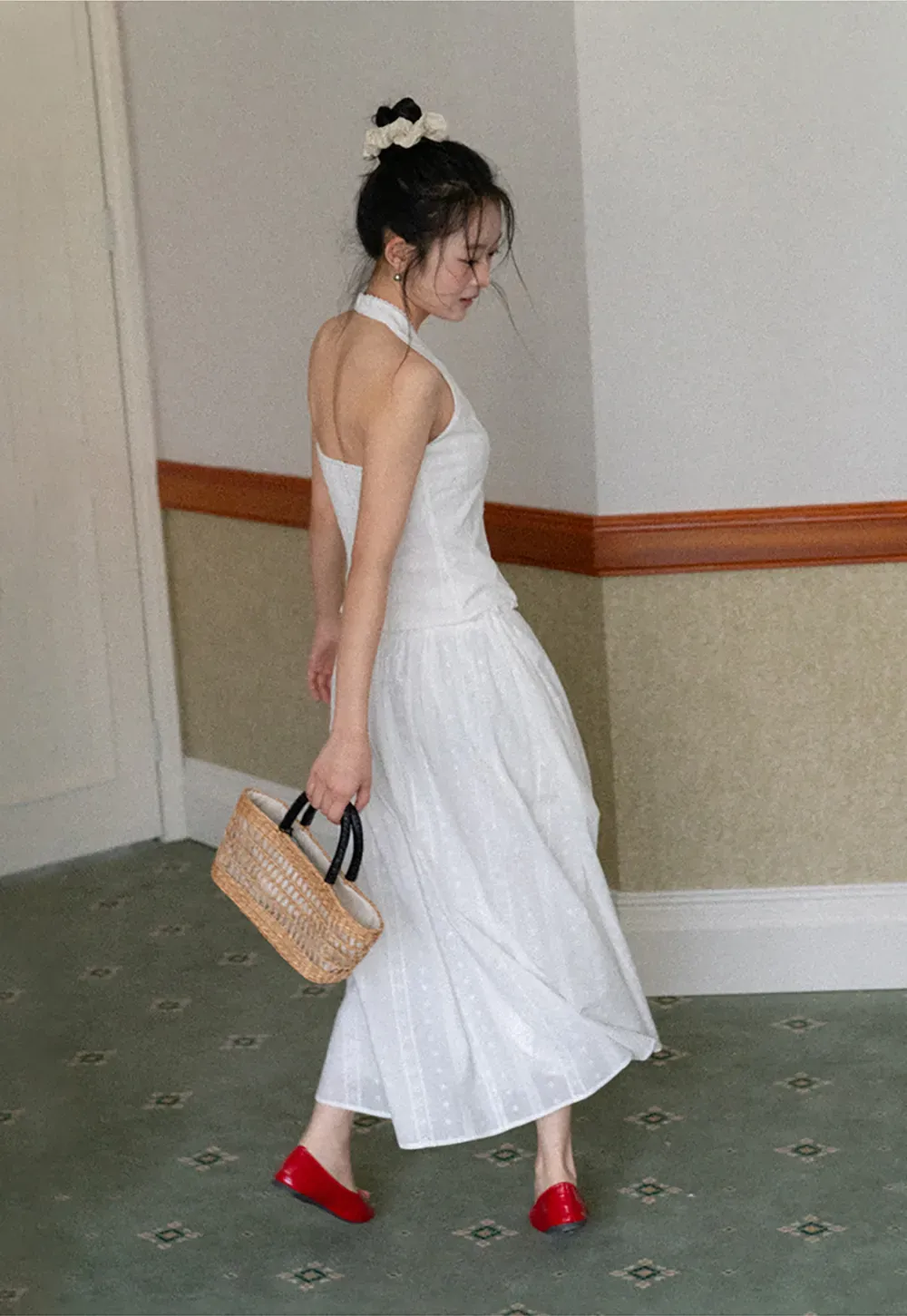 Halter neck sleeveless top with buttons and pleated skirt