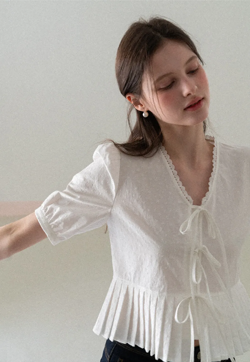 V neck short sleeve blouse with pleated hem and tie front