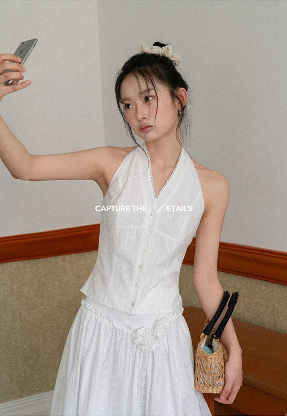 Halter neck sleeveless top with buttons and pleated skirt