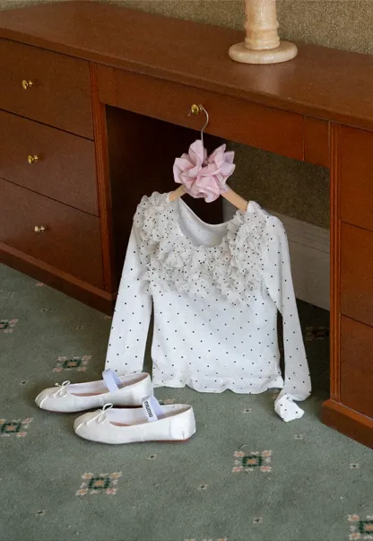 Polka dot long sleeve top with ruffled neckline