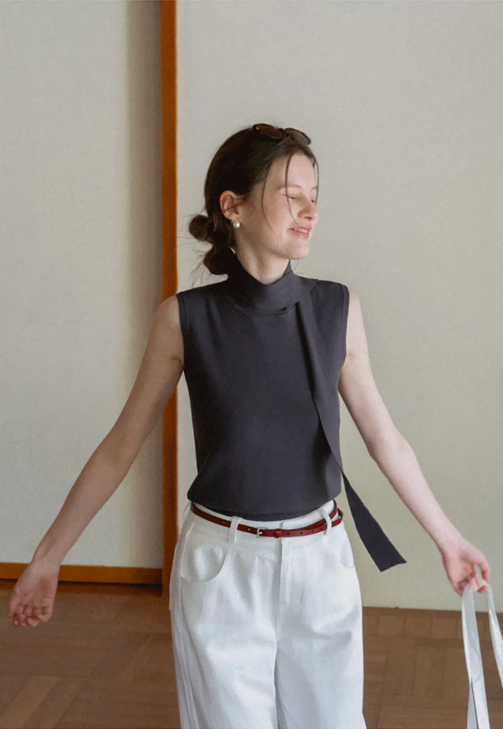 Sleeveless high neck knit top with side tie detail