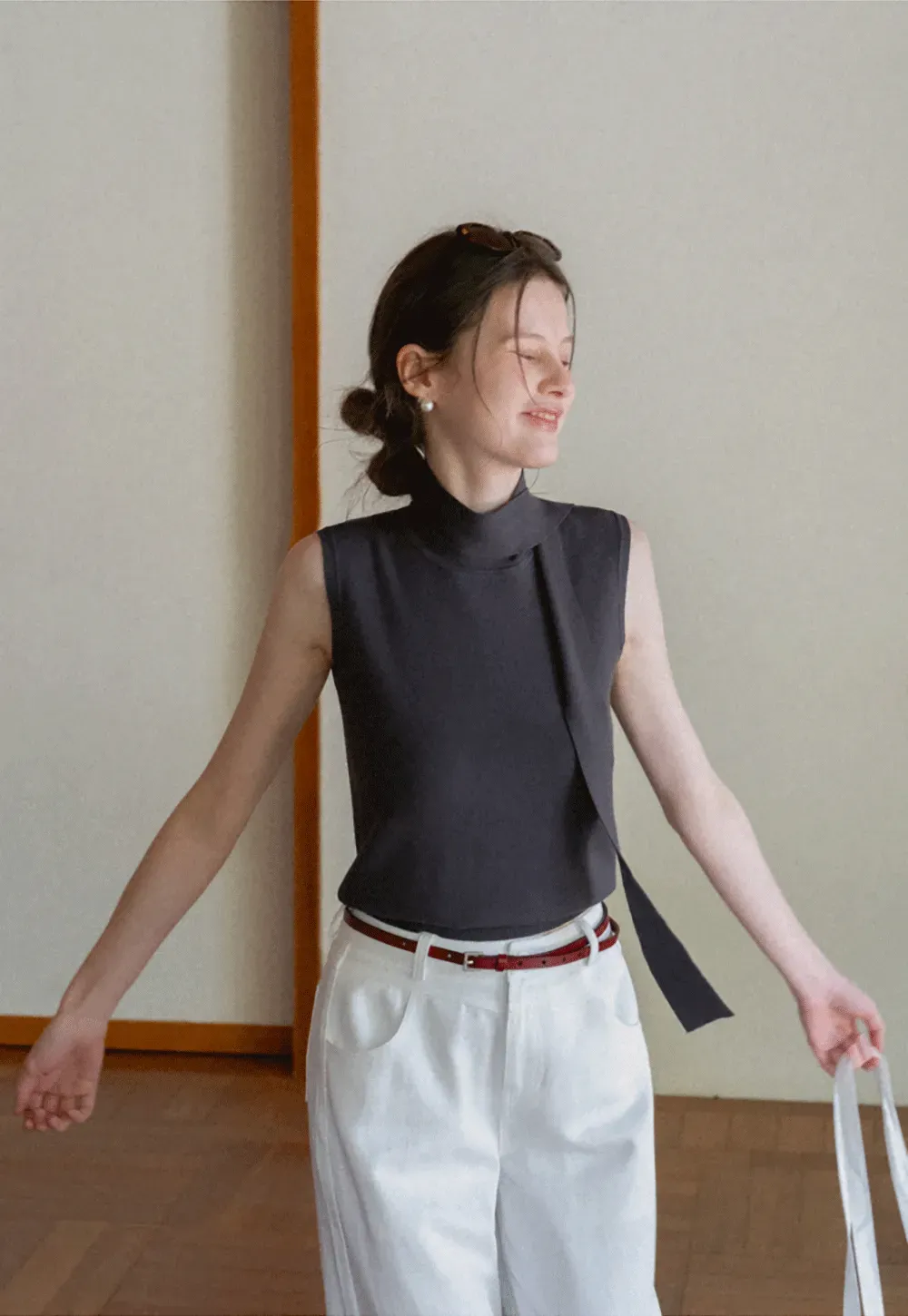 Sleeveless high neck knit top with side tie detail