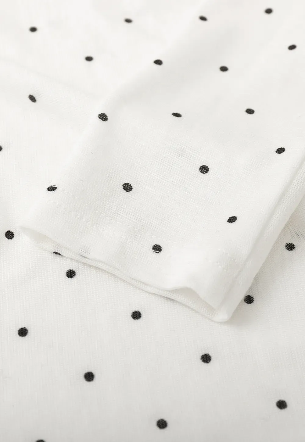 Polka dot long sleeve top with ruffled neckline