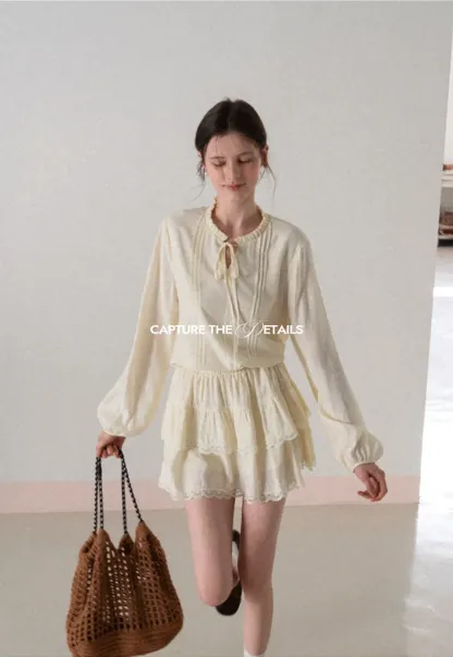 Shirt with ruffled collar and tie front layered skirt