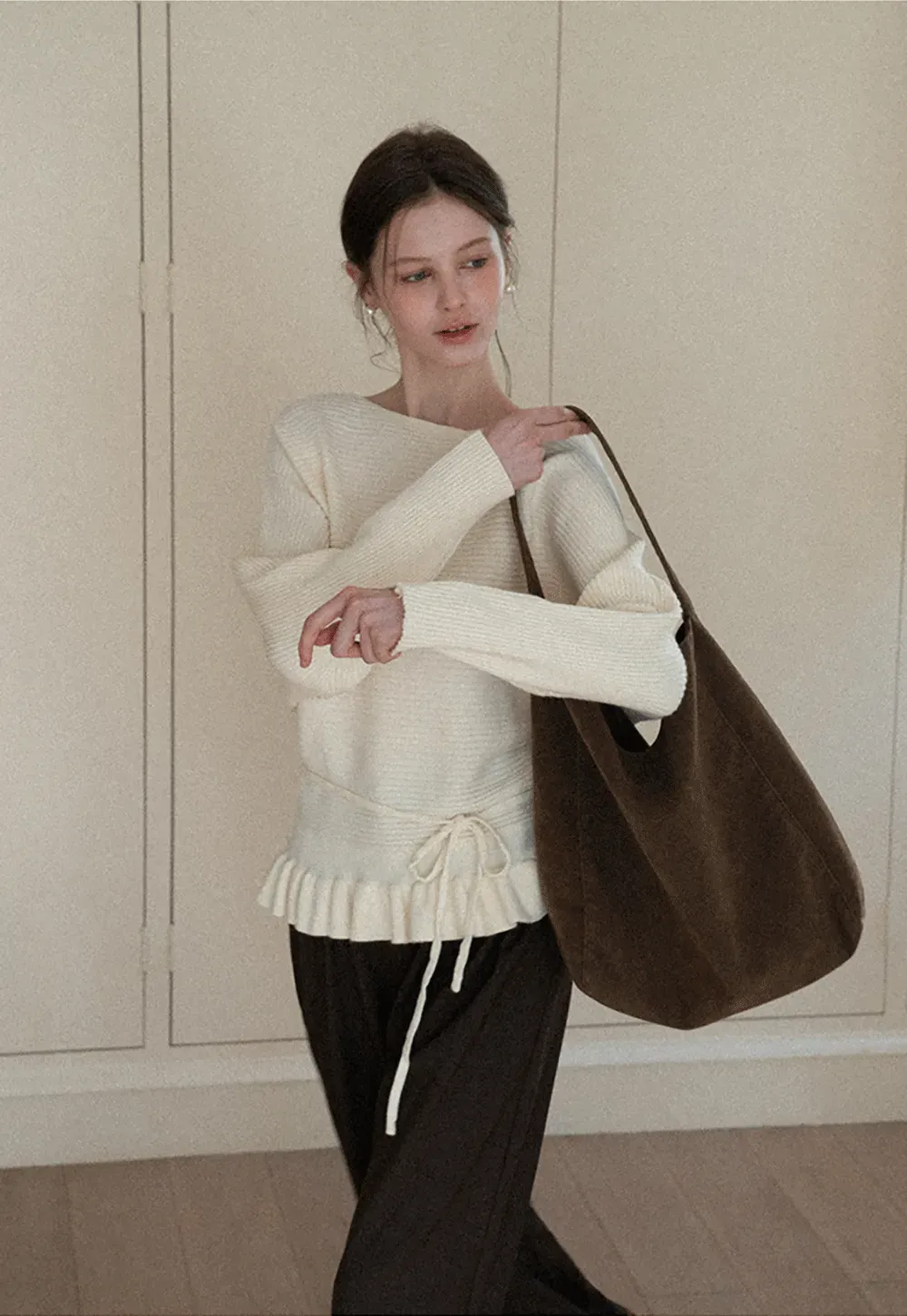 Ribbed knit sweater with tie back and flared hem design