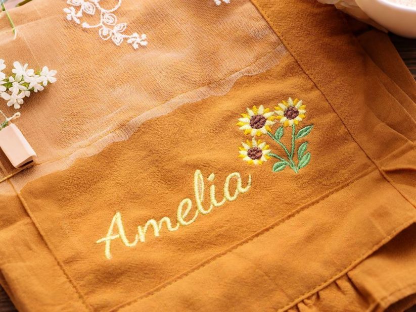 A close-up of the floral apron with soft home styling details.
