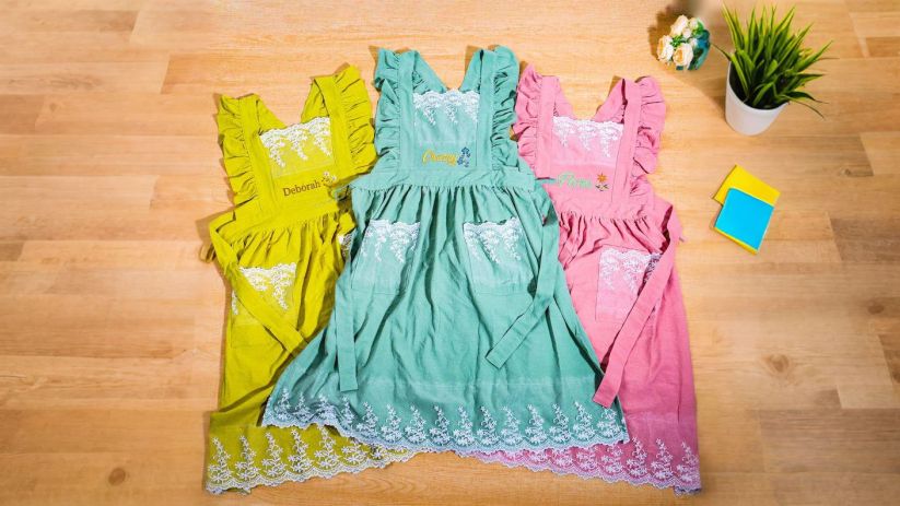 A floral apron styled for a cozy home kitchen moment.