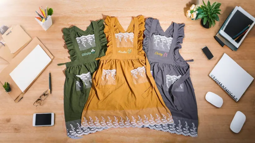 A floral embroidered apron styled as a thoughtful gift for a mother, baker, or home cook.