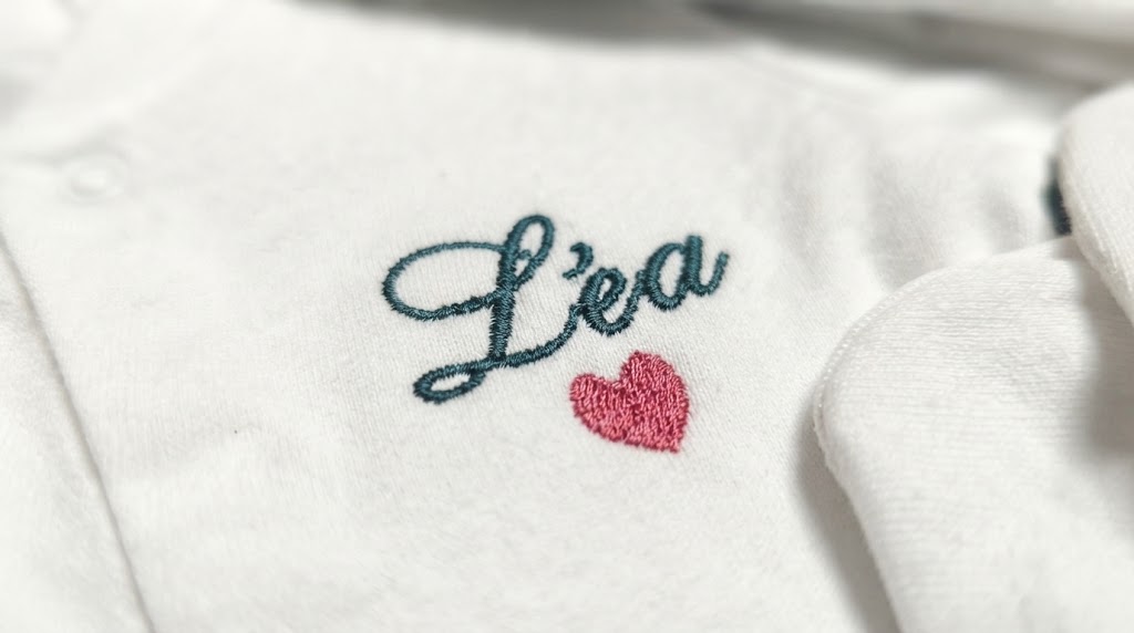 Close-up of a baby's name embroidered on newborn pajamas