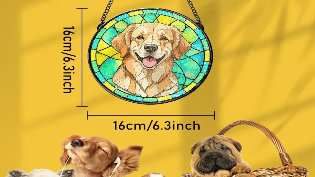 Stained glass style pet suncatcher hanging in a sunlit window, casting colorful light patterns onto a windowsill with small potted plants