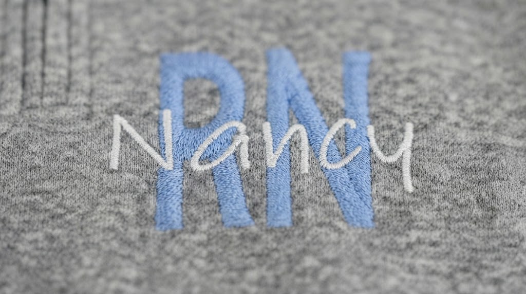 Close-up of embroidered RN name detail on personalized nurse jacket