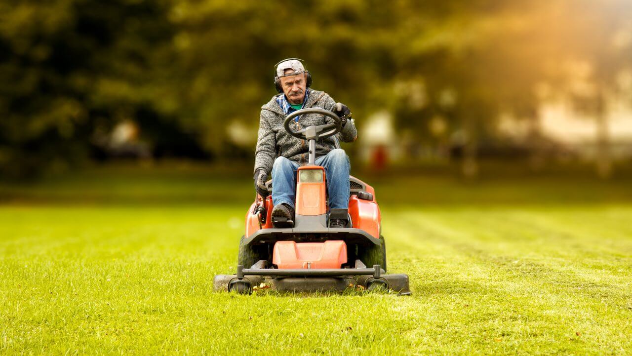 Man mowing using a riding mower
