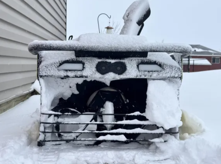 Yarbo snow blower covered in snow 