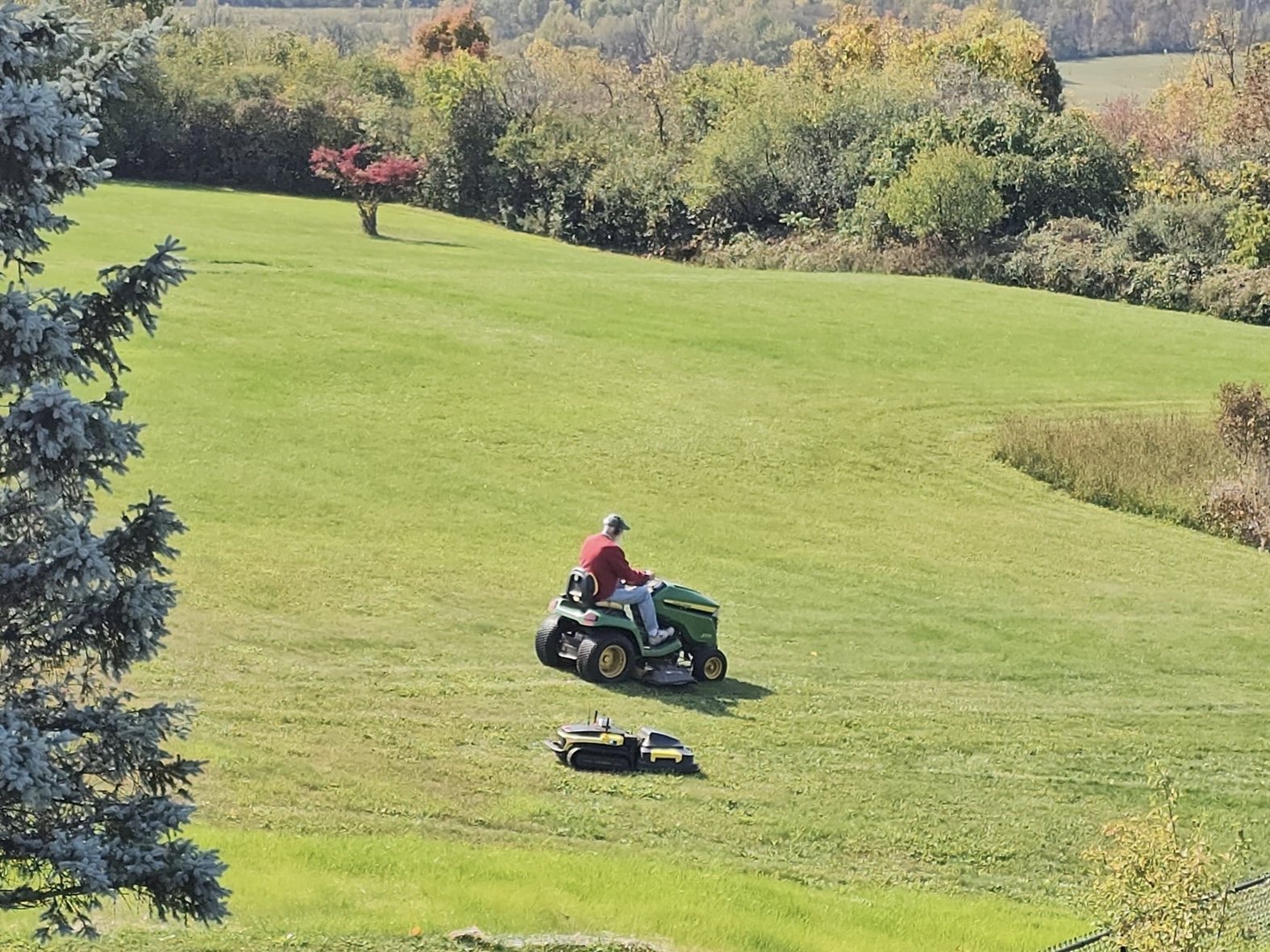 Robot and traditional lawn mower side by side