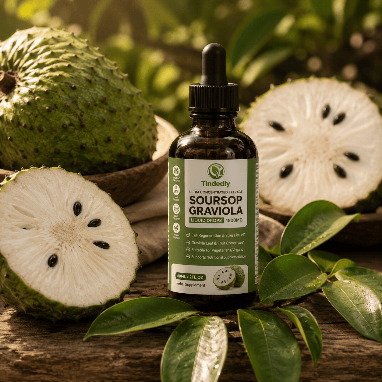 Fresh organic soursop fruit and leaves beside the Tindedly bottle.