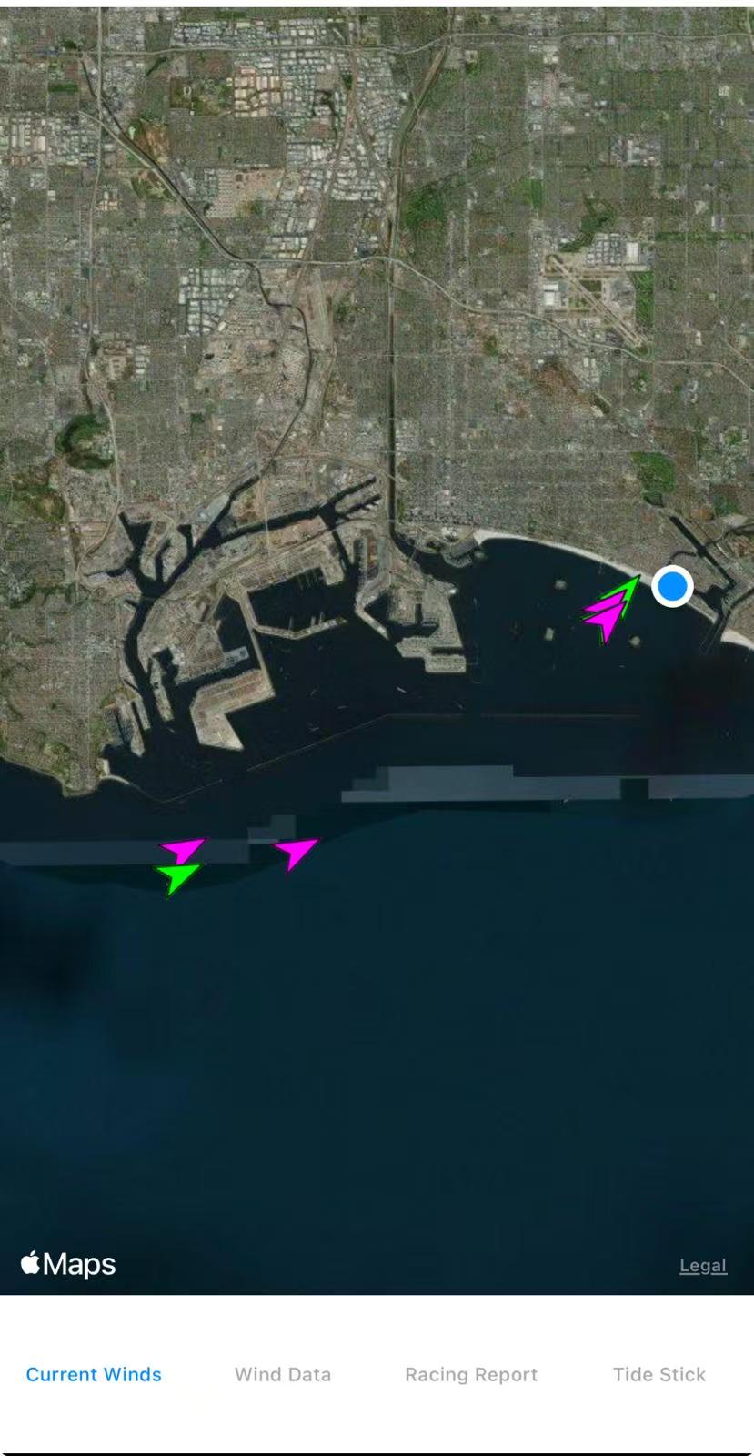 Sailing training interface showing a coastal satellite map, colored directional markers, a blue location marker and Current Winds, Wind Data, Racing Report and Tide Stick tabs
