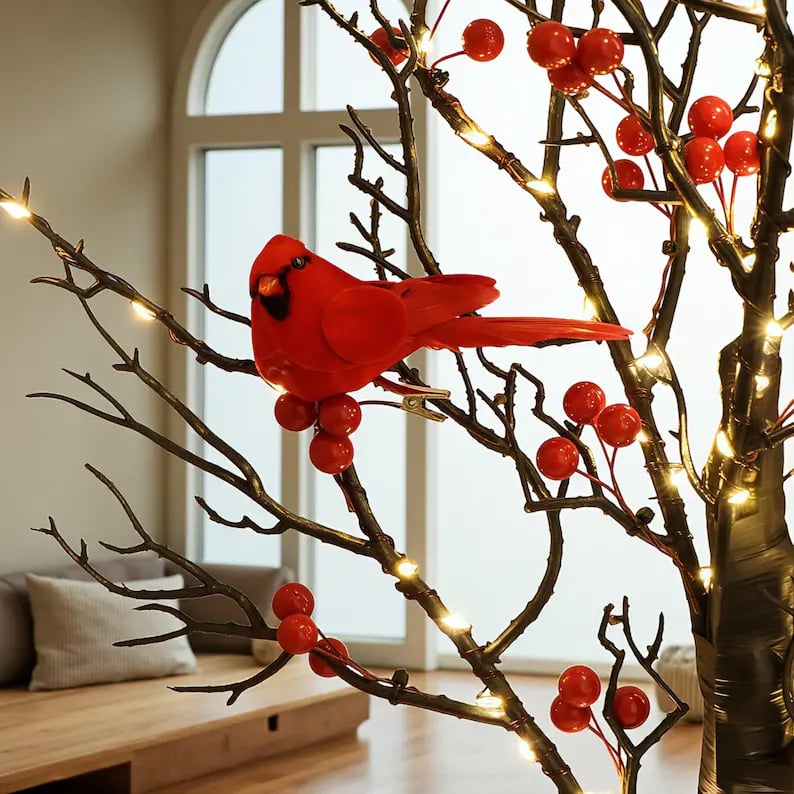May include: A decorative tree with dark brown branches, red berries, and small lights. A bright red cardinal bird is perched on a branch. The tree is a festive holiday decoration.