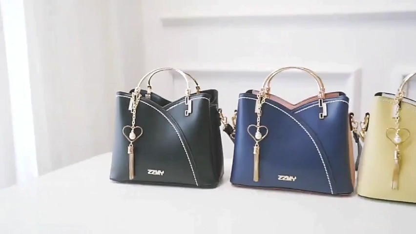 Women's Leather Handbag with Heart Tassel Charm 