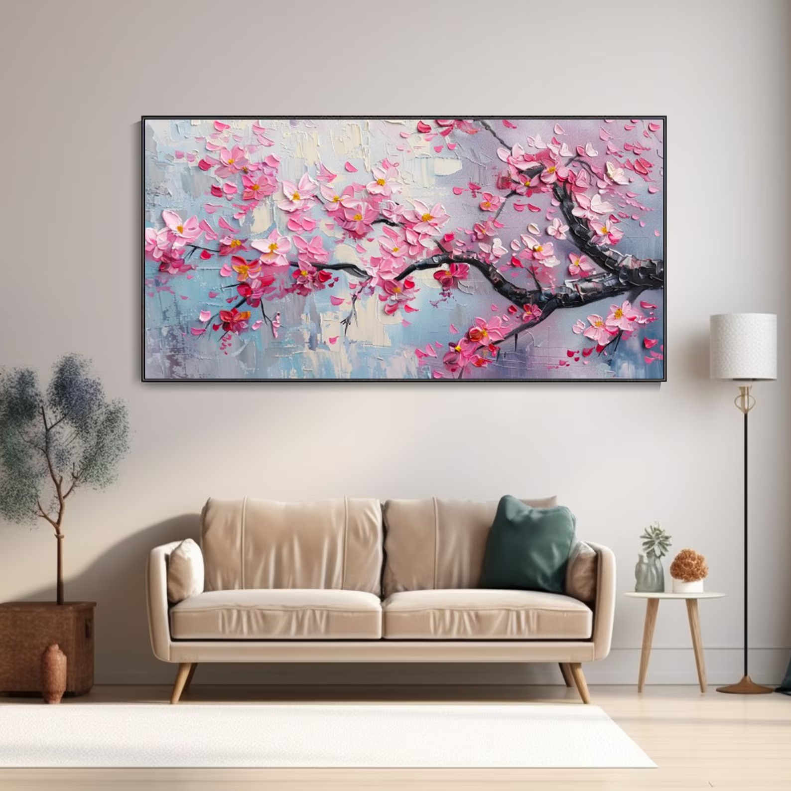 Modern pink cherry blossom wall art above a beige sofa in a cozy living room, paired with green plants and a neutral color scheme.