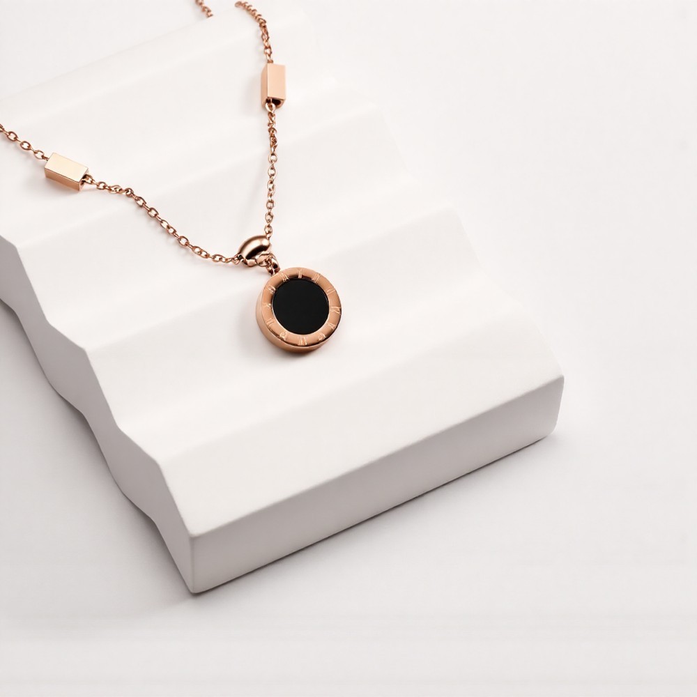 Rose gold Roman numeral two-tone black and white disc pendant necklace