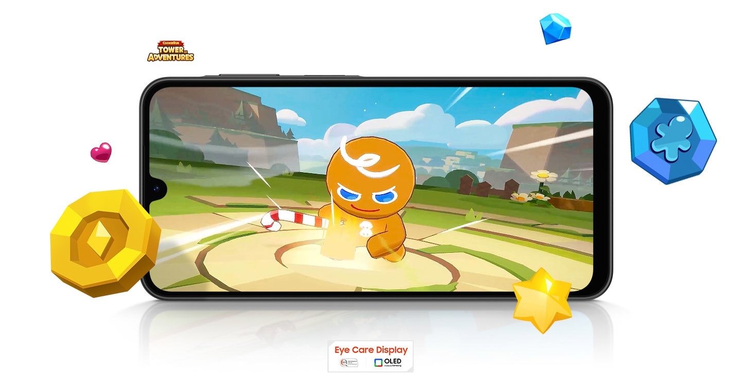 A Galaxy A26 5G device running the mobile game Cookie Run in landscape mode. Game items are scattered around the screen. Nearby are the COOKIE RUN TOWER OF ADVENTURES logo and the Eye Care Display and OLED technology logo.