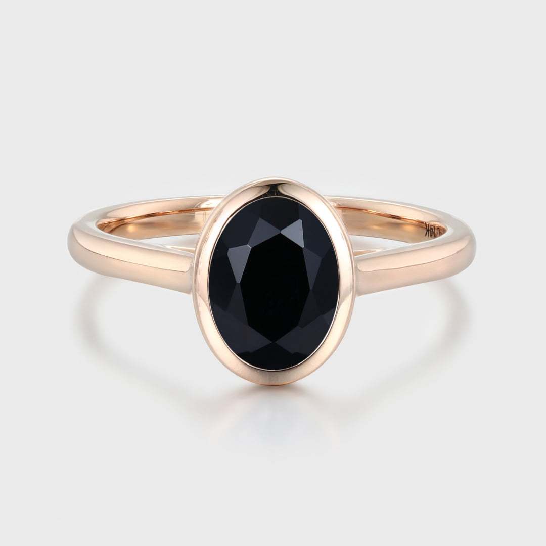 Simplicity meets elegance in our Oval Cut Solitaire Bezel Black Onyx Engagement Ring. It's a timeless symbol of love and beauty.