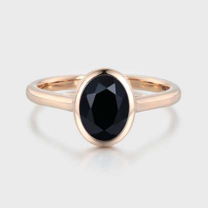 Simplicity meets elegance in our Oval Cut Solitaire Bezel Black Onyx Engagement Ring. It's a timeless symbol of love and beauty.