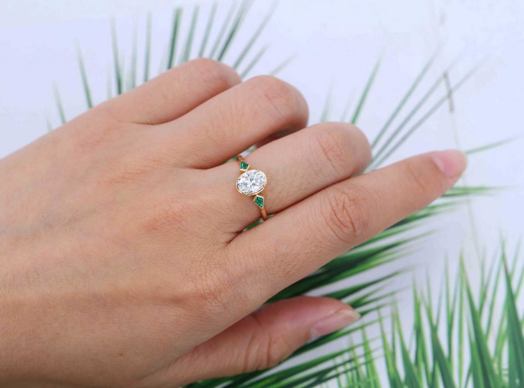 Bezel Set Oval Cut Moissanite Engagement Ring Unique 14K Yellow Gold Lab Emerald Side Stone Ring Delicate Wedding Ring
