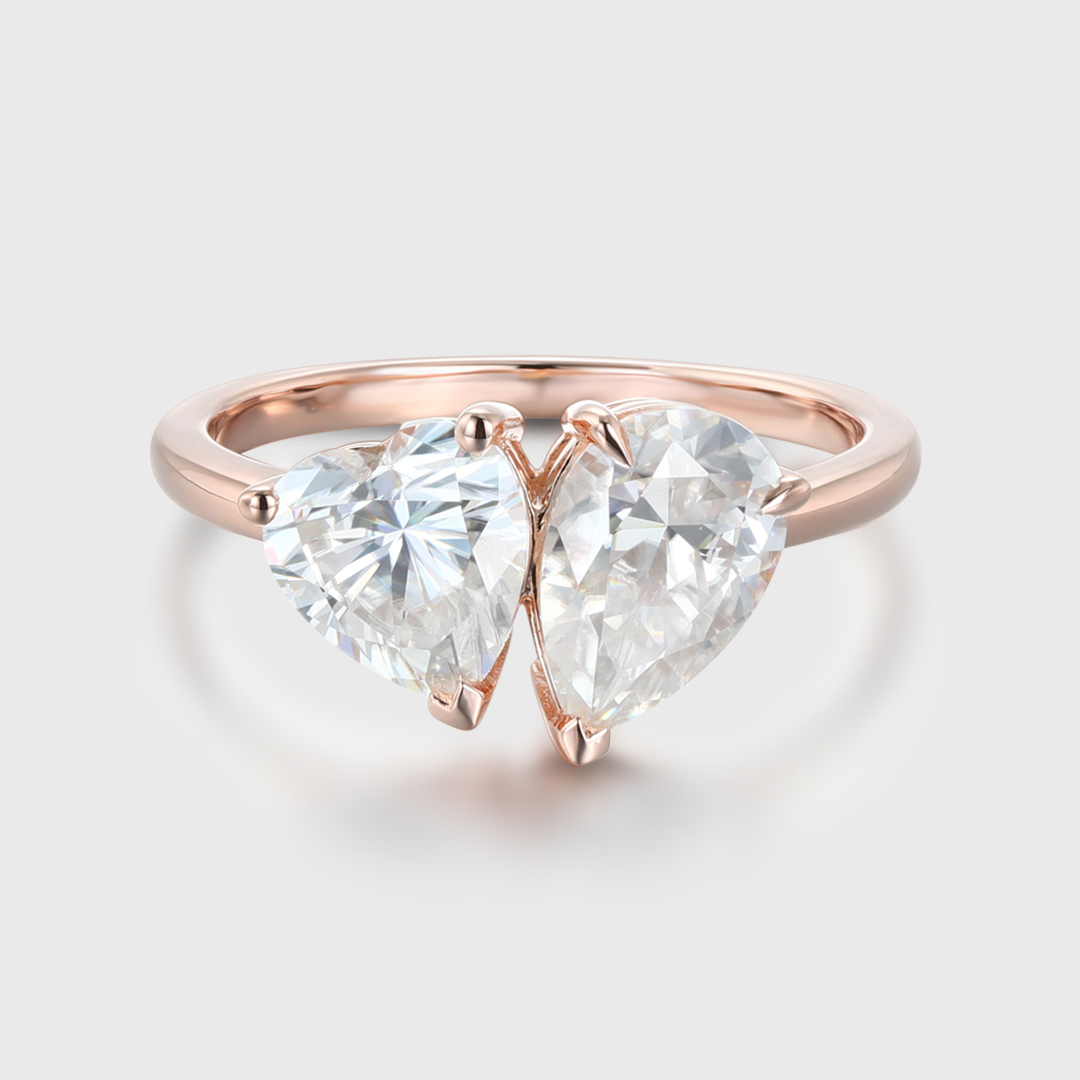 Heart shaped and pear cut lab-grown diamond engagement ring in 14K rose gold, featuring a two-stone Toi et Moi design, perfect for engagements and anniversaries.