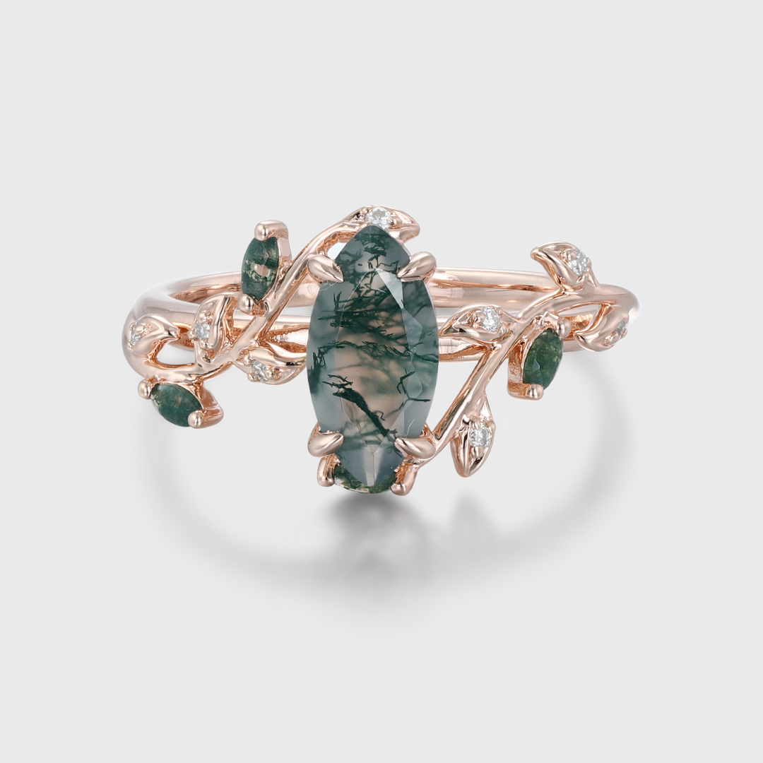 Nature-inspired marquise cut moss agate promise ring with a rose gold twist leaf branch design, perfect for anniversaries or engagements.
