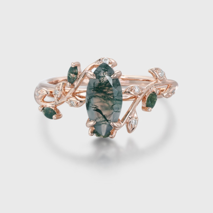 Nature-inspired marquise cut moss agate promise ring with a rose gold twist leaf branch design, perfect for anniversaries or engagements.