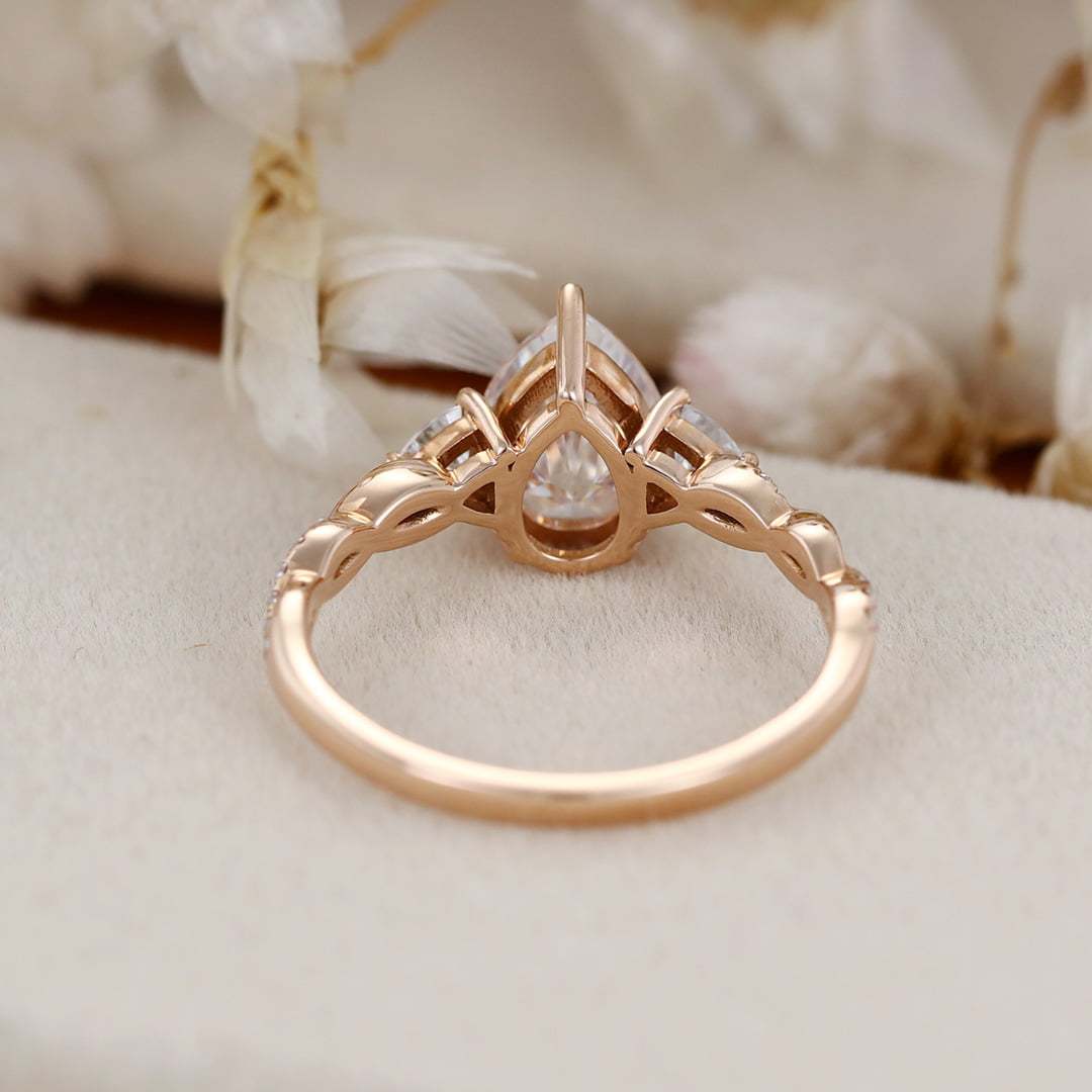 1.5 Carat Pear Shape Moissanite Twist Engagement Ring In 14K Rose Gold