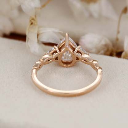 1.5 Carat Pear Shape Moissanite Twist Engagement Ring In 14K Rose Gold