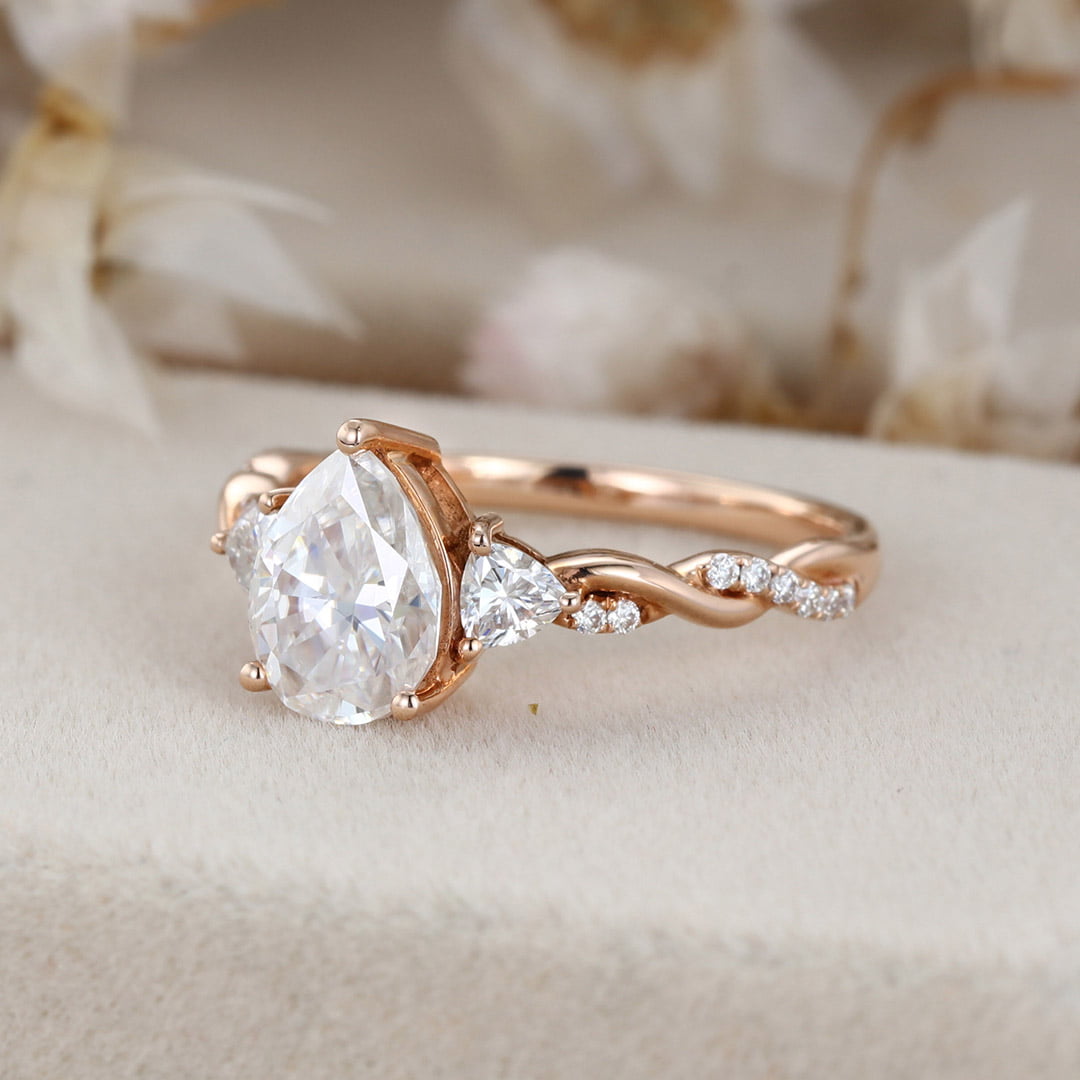1.5 Carat Pear Shape Moissanite Twist Engagement Ring In 14K Rose Gold