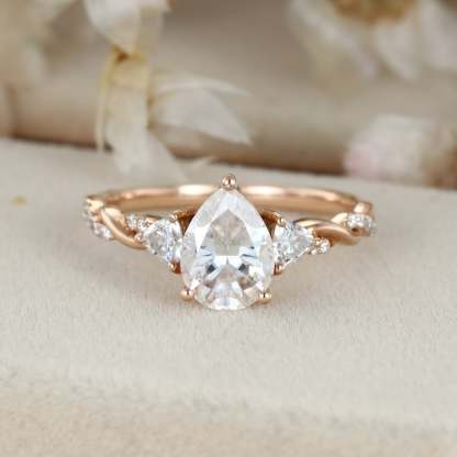 1.5 Carat Pear Shape Moissanite Twist Engagement Ring In 14K Rose Gold